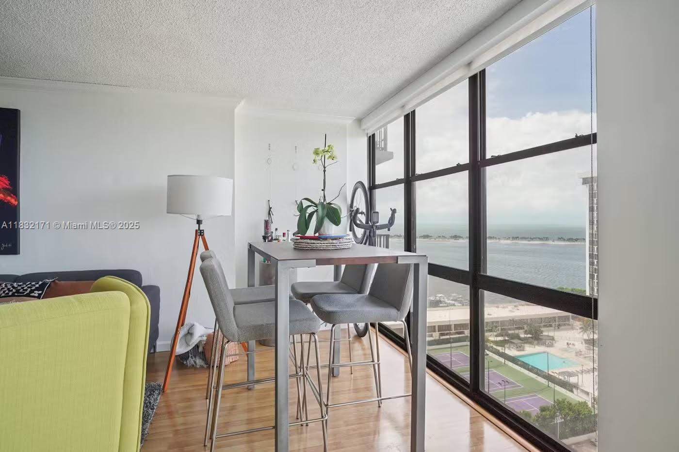 1901 Brickell Avenue, Unit B1706 Miami, FL 33129 - Photo 2 of 15 a dining room with furniture and a floor to ceiling window