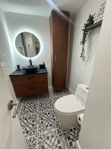 a living room with a toilet and a mirror