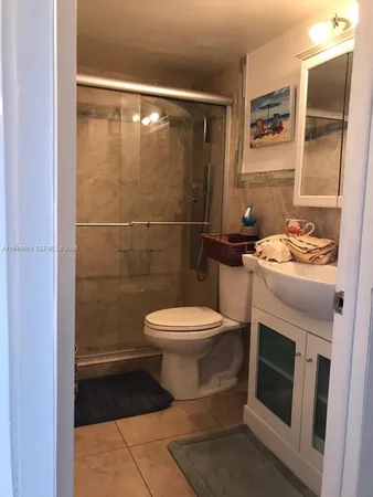 a bathroom with a toilet a sink and shower