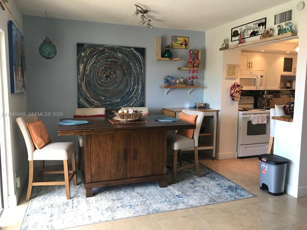 320 South Surf Road, Unit 305 Hollywood, FL 33019 - Photo 8 of 23 a living room with furniture and a rug