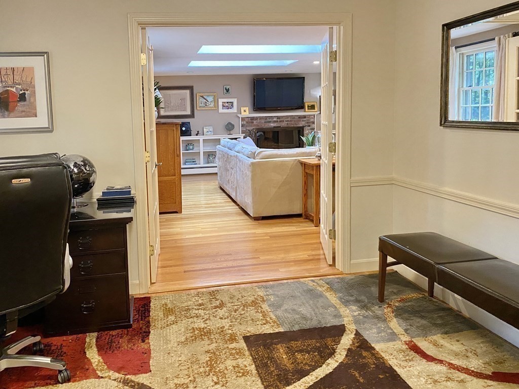 7 Ledgewood Circle Topsfield, MA 01983 - Photo 16 of 36 a living room with furniture a flat screen tv and a rug