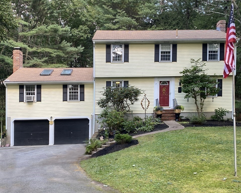 7 Ledgewood Circle Topsfield, MA 01983 - Photo 3 of 36 a front view of a house with a garden and plants