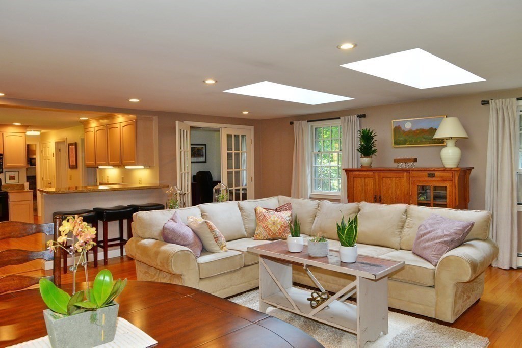 7 Ledgewood Circle Topsfield, MA 01983 - Photo 6 of 36 a living room with furniture and a dining table with kitchen view