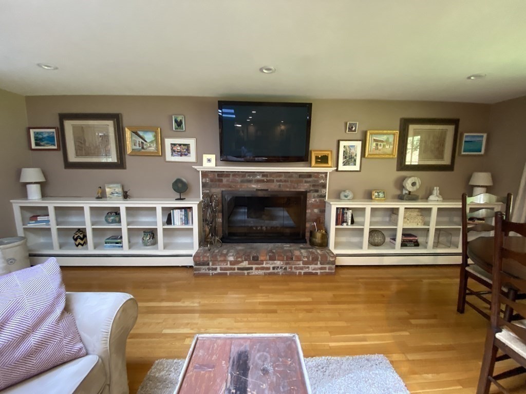 7 Ledgewood Circle Topsfield, MA 01983 - Photo 8 of 36 a living room with furniture a flat screen tv and a fireplace