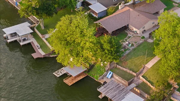 an aerial view of a house with a garden and swimming pool