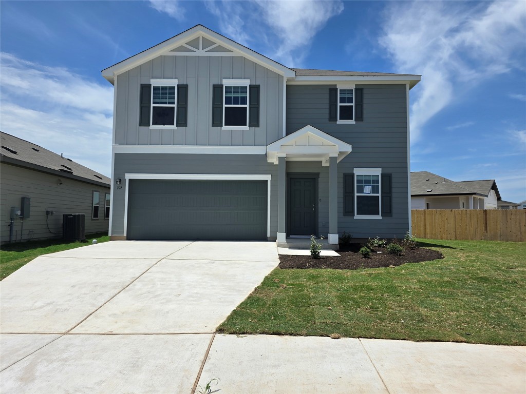 a front view of a house with a yard and garage