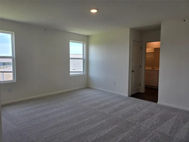 an empty room with windows and closet