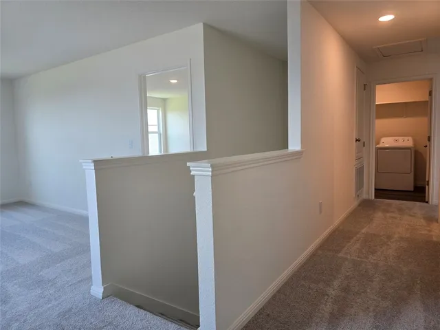 a view of a hallway with an entryway