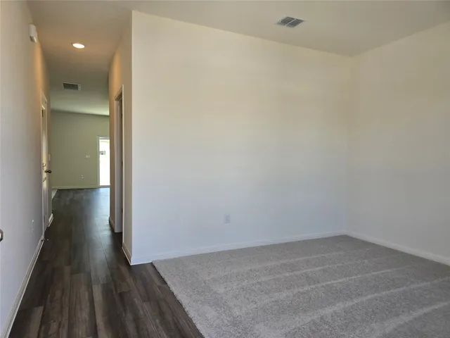 a view of a room with wooden floor and a sink