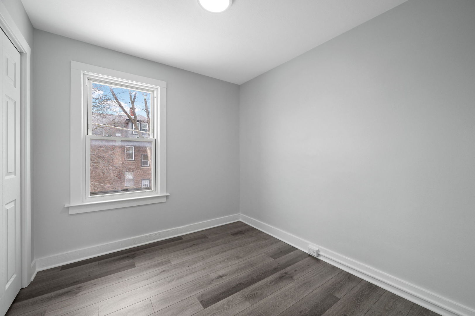 423 Funston Avenue, Unit 2F Highwood, IL 60040 - Photo 11 of 13 an empty room with wooden floor and windows