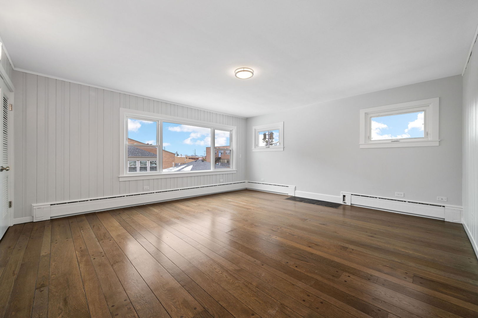 423 Funston Avenue, Unit 2F Highwood, IL 60040 - Photo 2 of 13 an empty room with wooden floor and windows