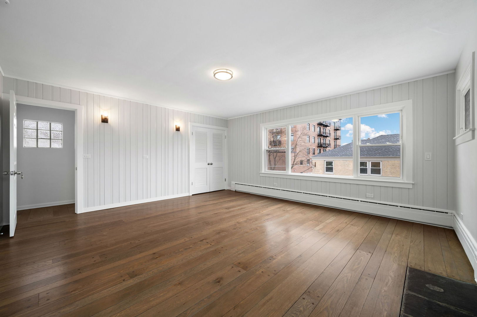 423 Funston Avenue, Unit 2F Highwood, IL 60040 - Photo 3 of 13 an empty room with wooden floor and windows
