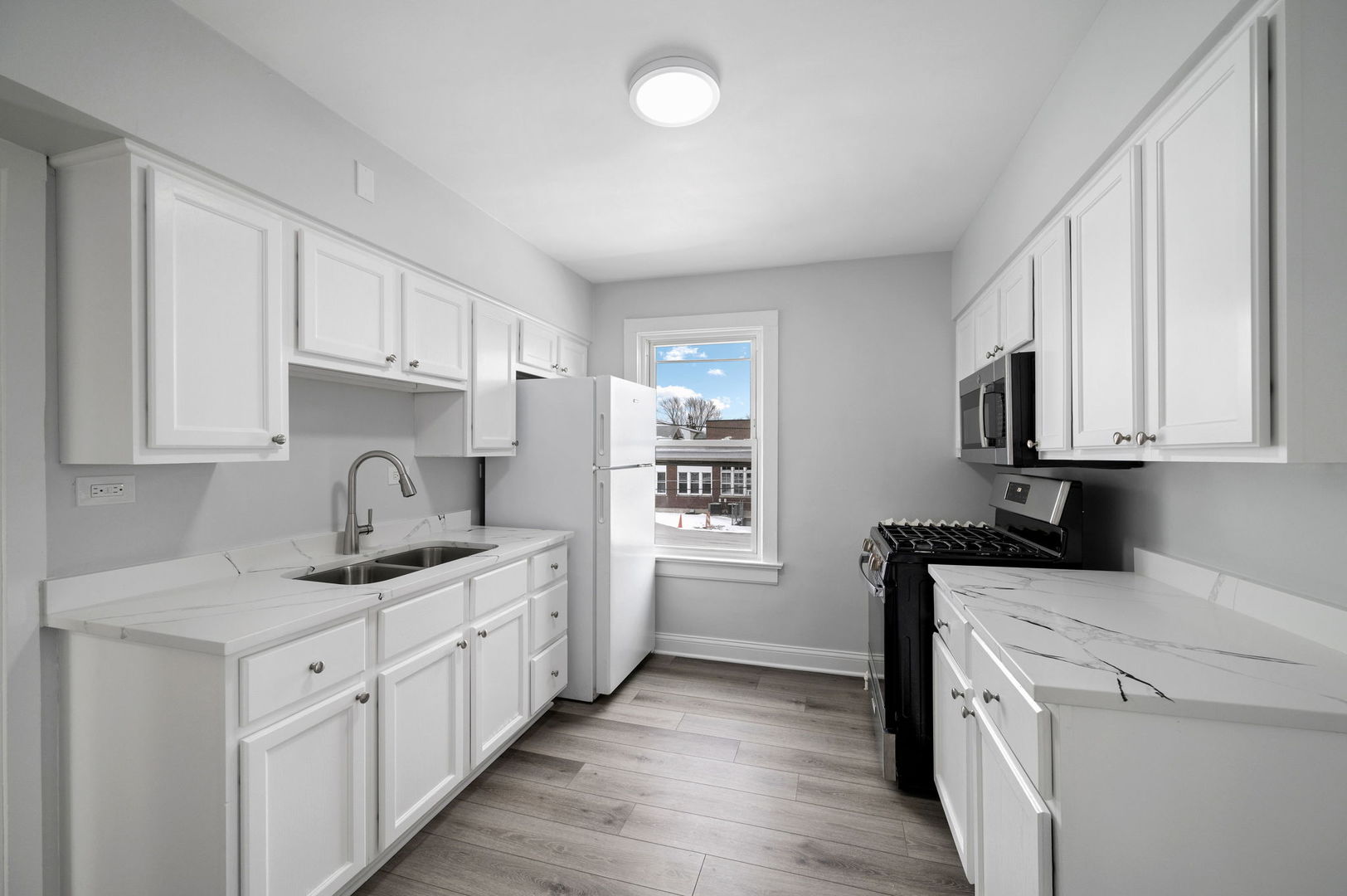 423 Funston Avenue, Unit 2F Highwood, IL 60040 - Photo 4 of 13 a kitchen with stainless steel appliances granite countertop a sink stove and cabinets