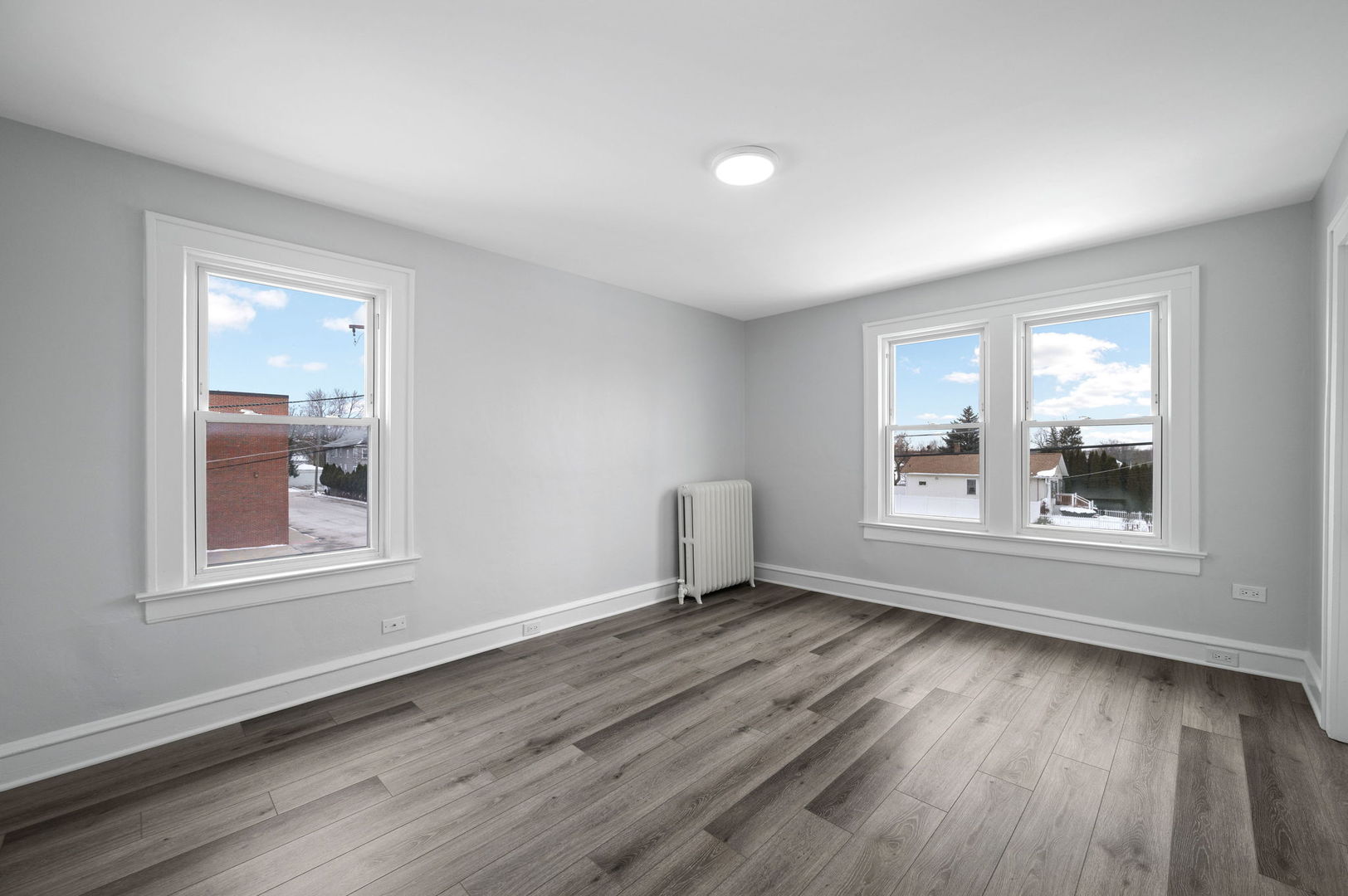 423 Funston Avenue, Unit 2F Highwood, IL 60040 - Photo 6 of 13 an empty room with wooden floor and windows