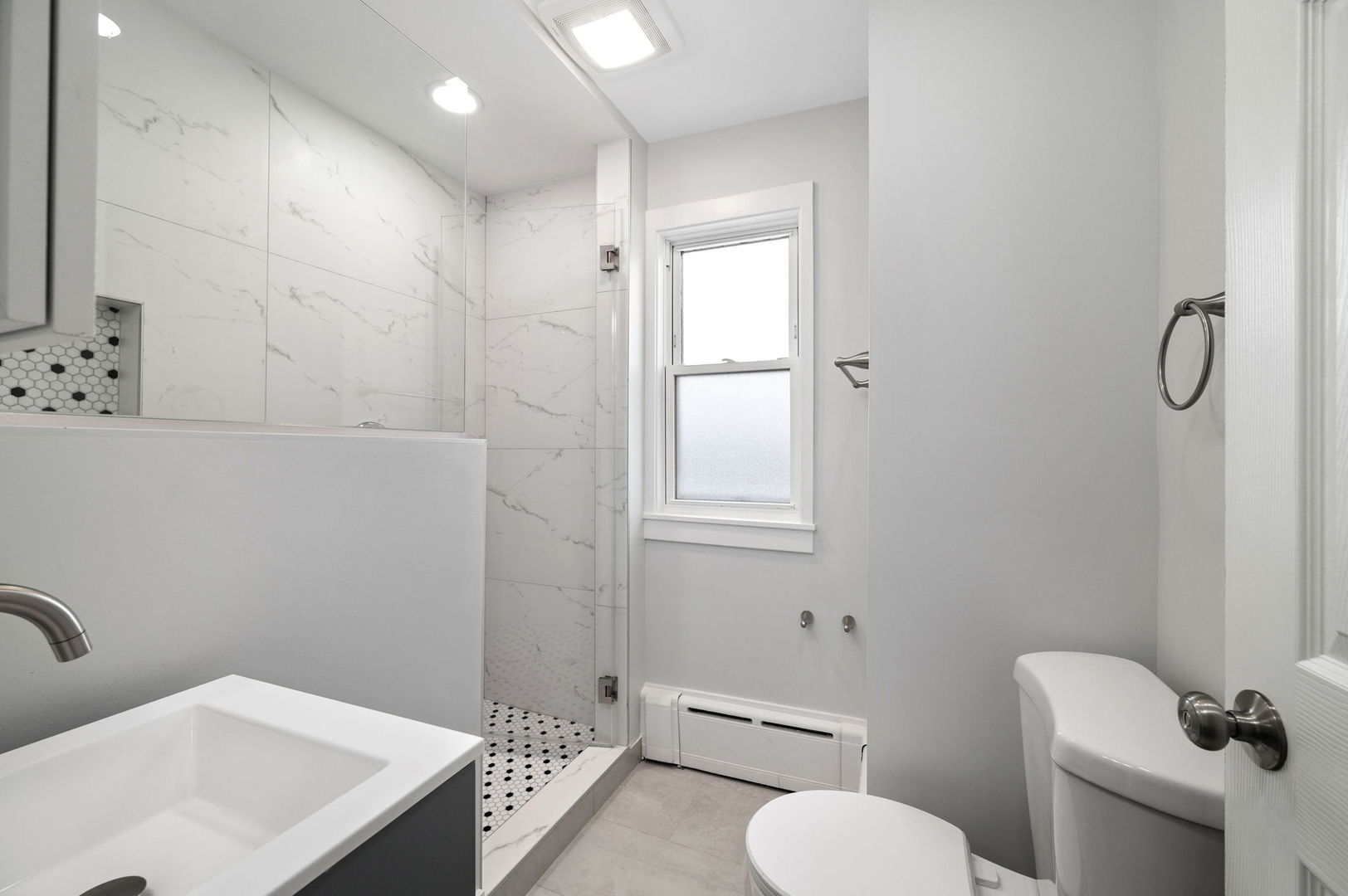 423 Funston Avenue, Unit 2F Highwood, IL 60040 - Photo 8 of 13 a bathroom with a toilet sink and mirror