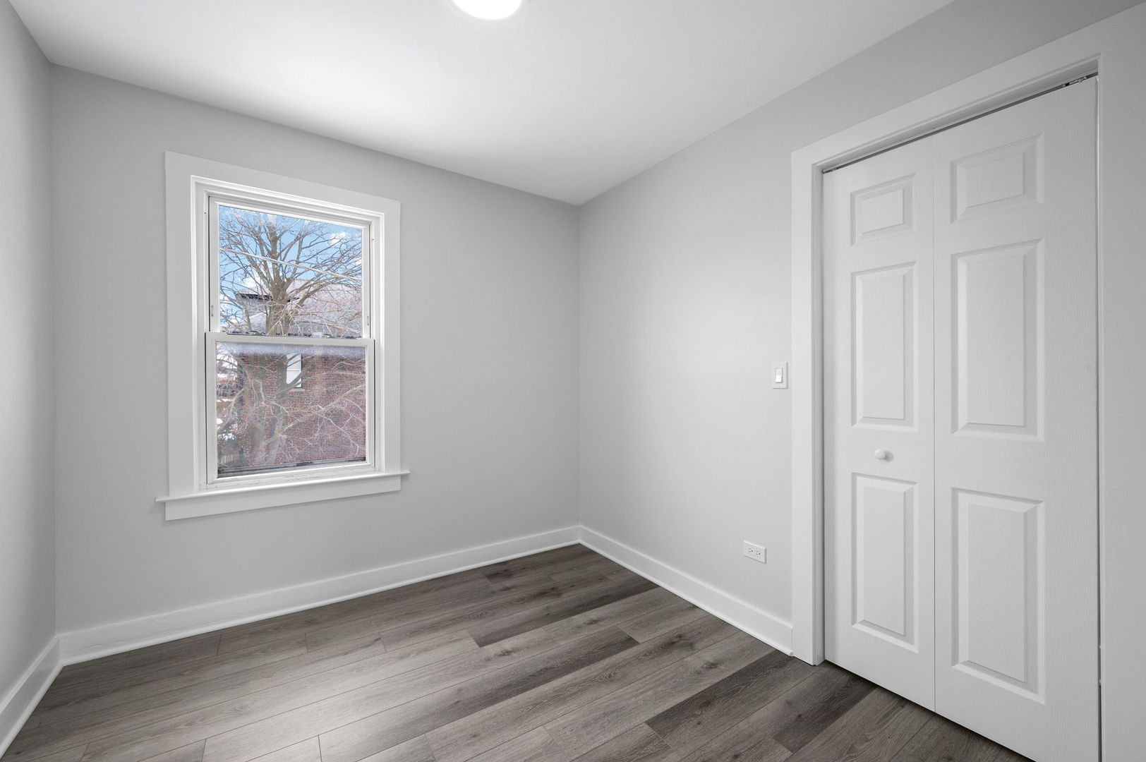423 Funston Avenue, Unit 2F Highwood, IL 60040 - Photo 10 of 13 an empty room with wooden floor and windows