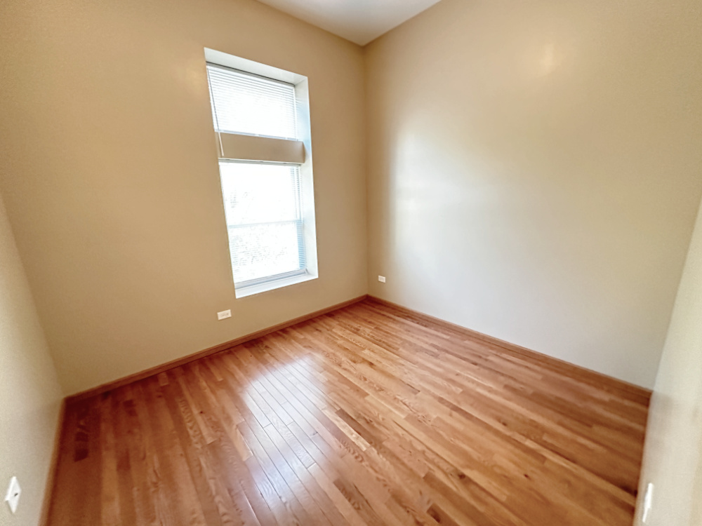 639 West Garfield Boulevard, Unit 3 Chicago, IL 60621 - Photo 11 of 13 an empty room with wooden floor and windows