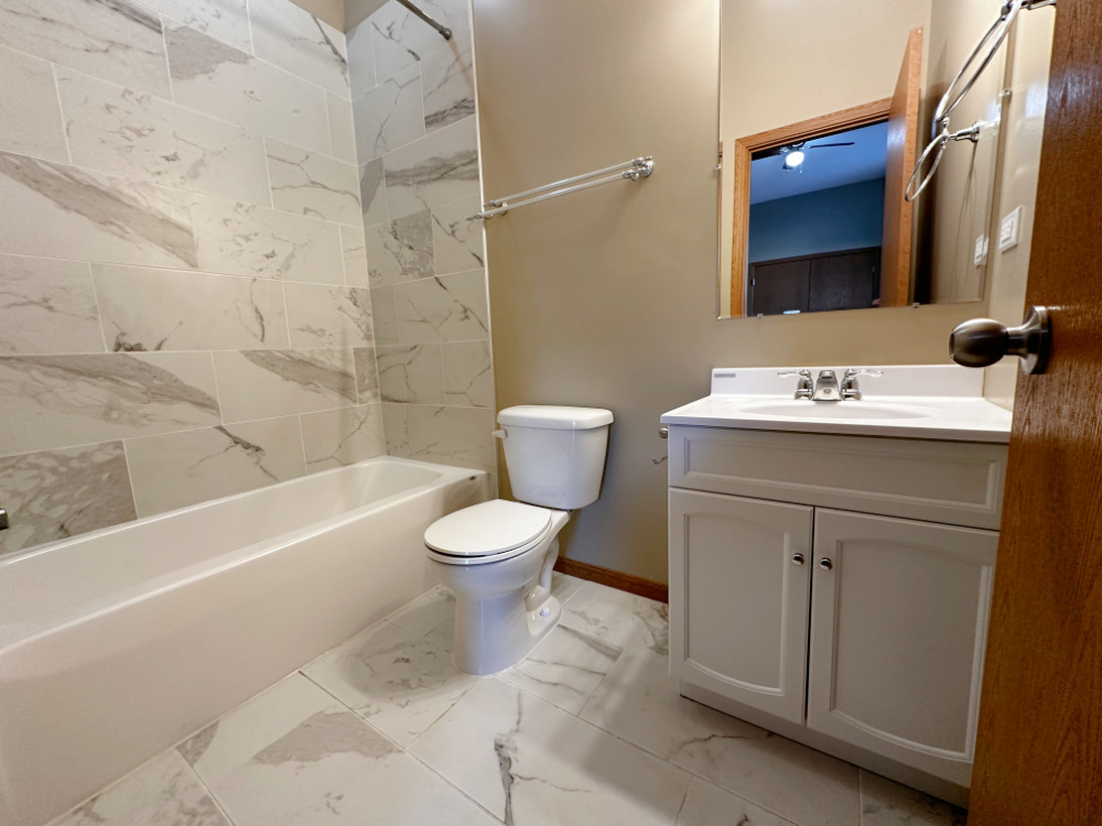 639 West Garfield Boulevard, Unit 3 Chicago, IL 60621 - Photo 12 of 13 a bathroom with a sink toilet and shower