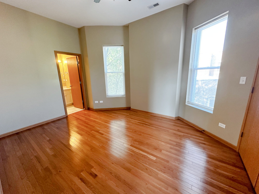 639 West Garfield Boulevard, Unit 3 Chicago, IL 60621 - Photo 5 of 13 an empty room with wooden floor and windows