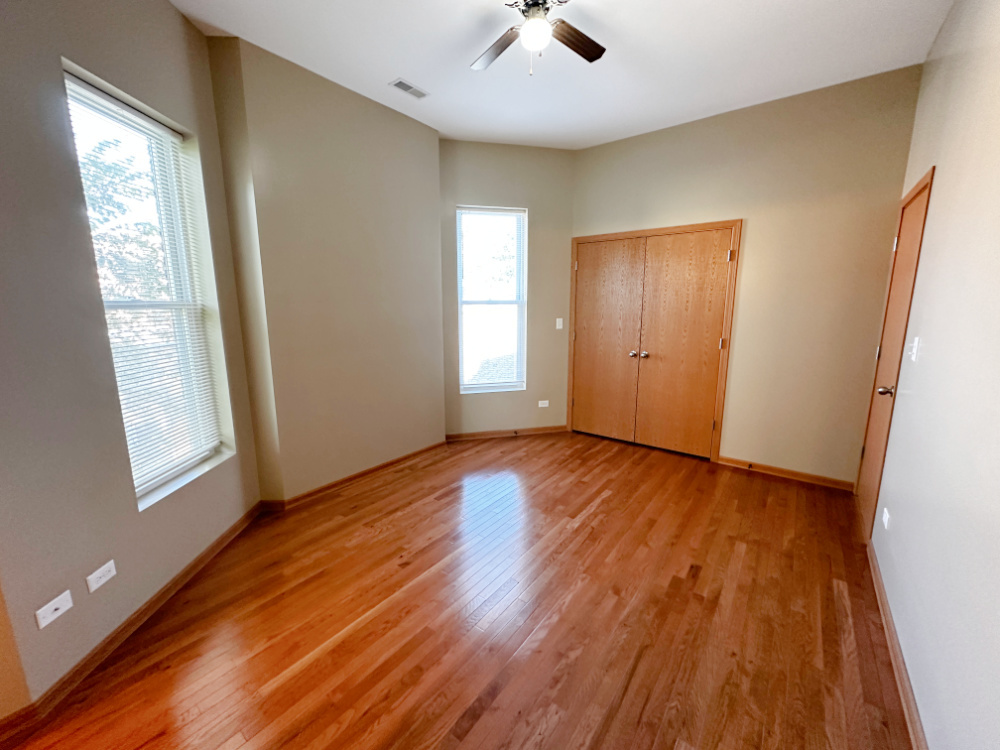 639 West Garfield Boulevard, Unit 3 Chicago, IL 60621 - Photo 6 of 13 an empty room with wooden floor and windows