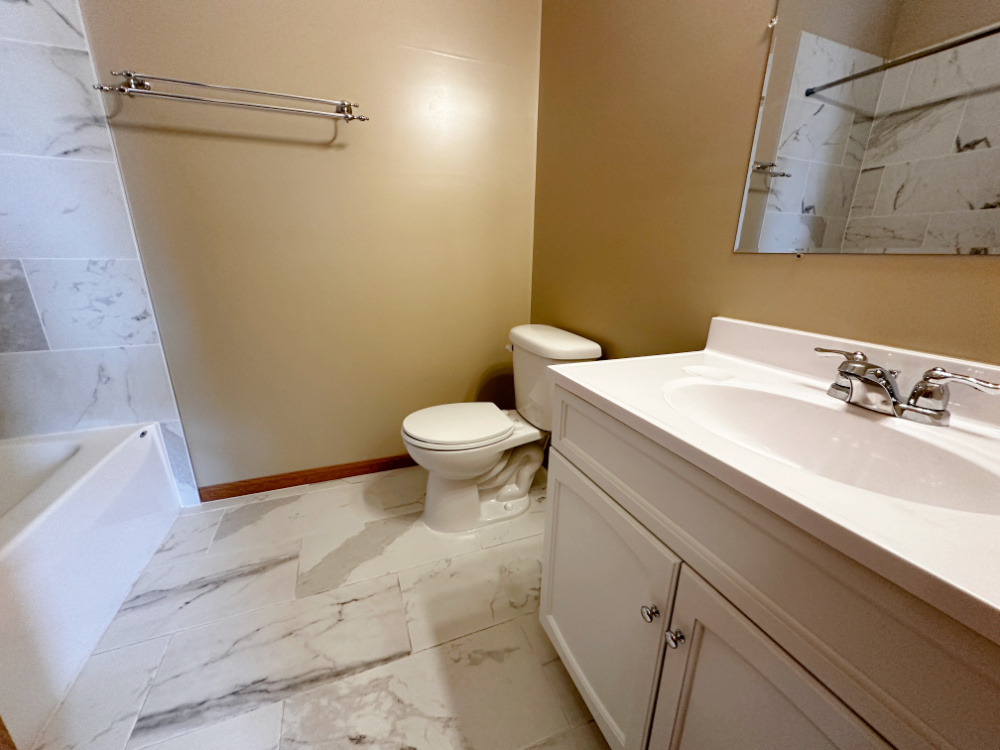 639 West Garfield Boulevard, Unit 3 Chicago, IL 60621 - Photo 7 of 13 a bathroom with a sink and a mirror