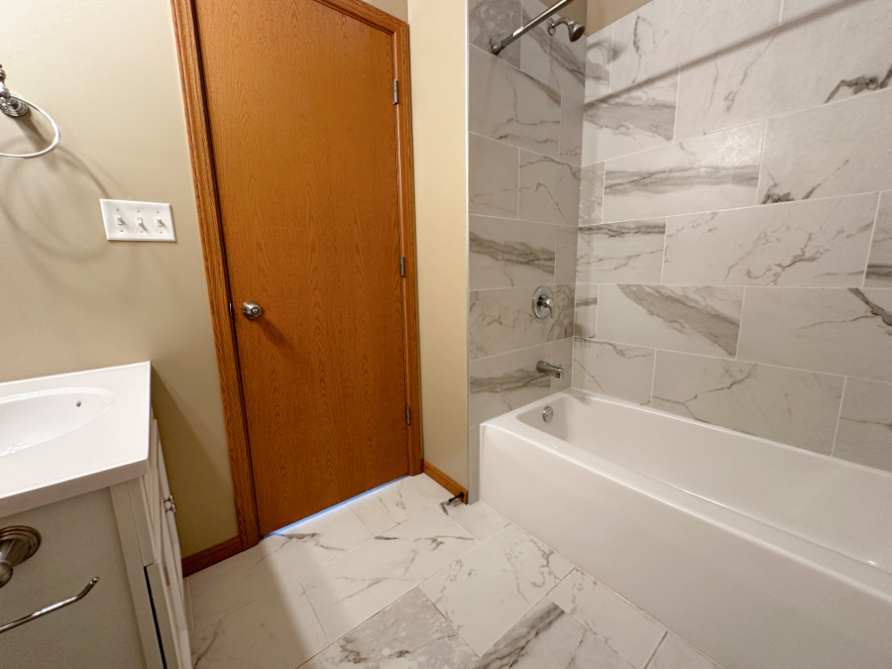 639 West Garfield Boulevard, Unit 3 Chicago, IL 60621 - Photo 8 of 13 a bathroom with a bathtub and a shower