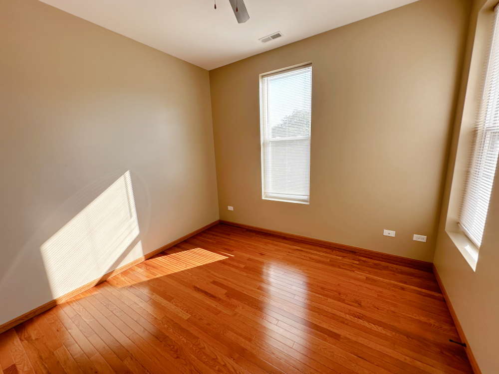 639 West Garfield Boulevard, Unit 3 Chicago, IL 60621 - Photo 9 of 13 an empty room with wooden floor and windows