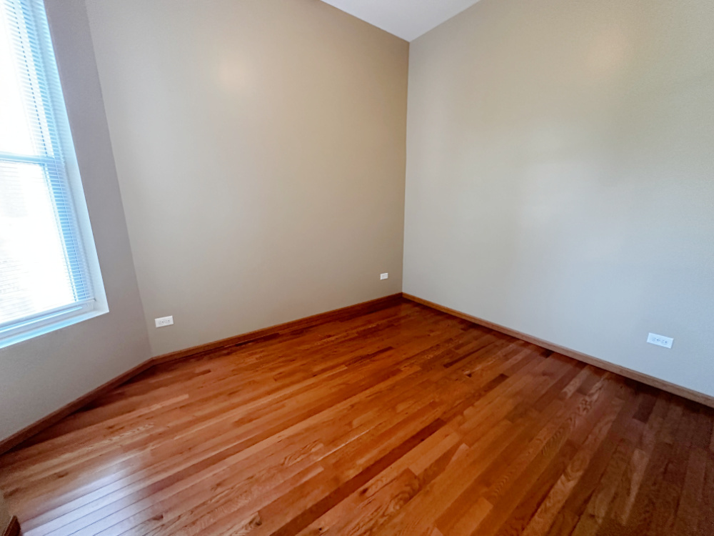 639 West Garfield Boulevard, Unit 3 Chicago, IL 60621 - Photo 10 of 13 a view of empty room with wooden floor and fan
