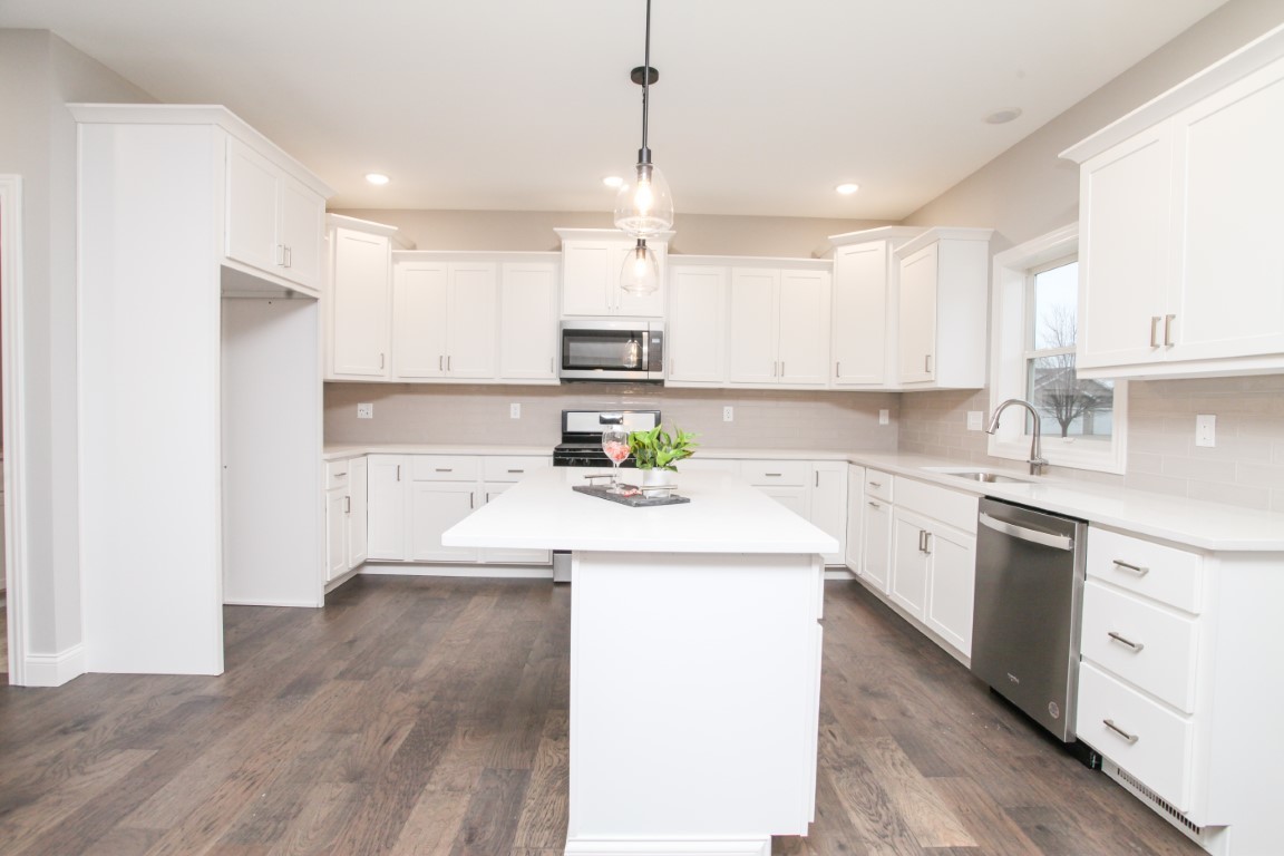 2702 Lone Oak Road Bloomington, IL 61705 - Photo 11 of 19 a kitchen with kitchen island white cabinets and white appliances