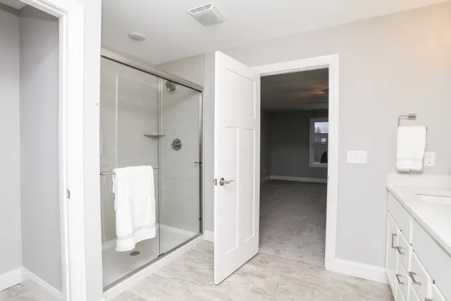 a view of a bathroom with a shower and a sink