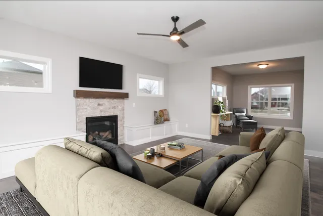 a living room with furniture a flat screen tv and a fireplace