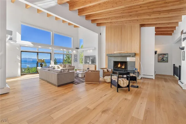 a view of a dining room with furniture large windows and wooden floor