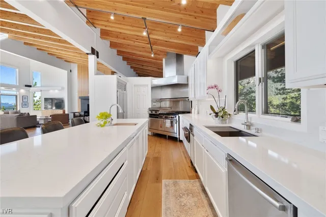 a bath room with a sink and a wooden floor