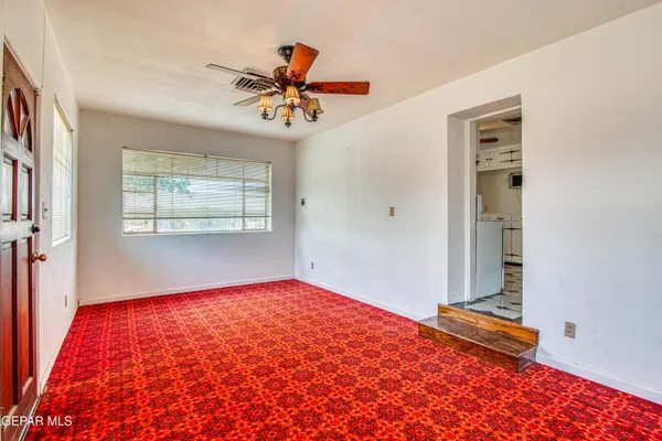 a kitchen with granite countertop cabinets a sink a stove and a window