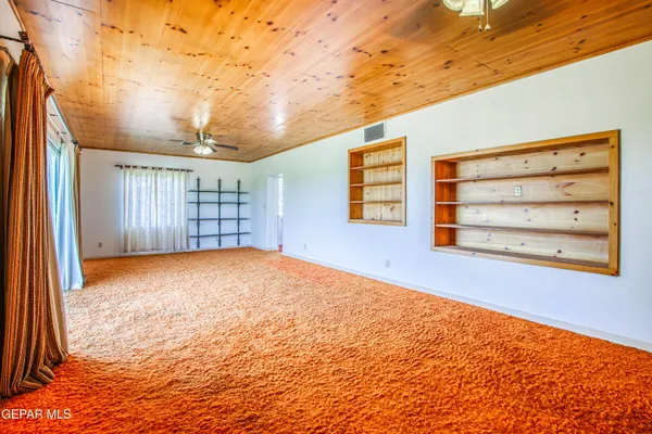 a view of a livingroom with wooden floor and a large window