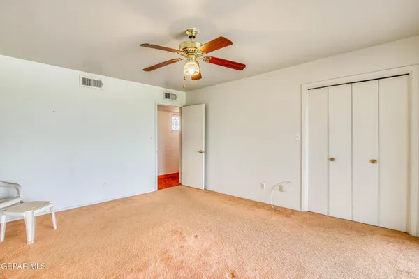 a view of a livingroom with a ceiling fan and window