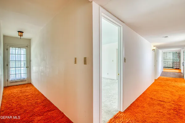 a view of a bedroom with wooden floor and windows