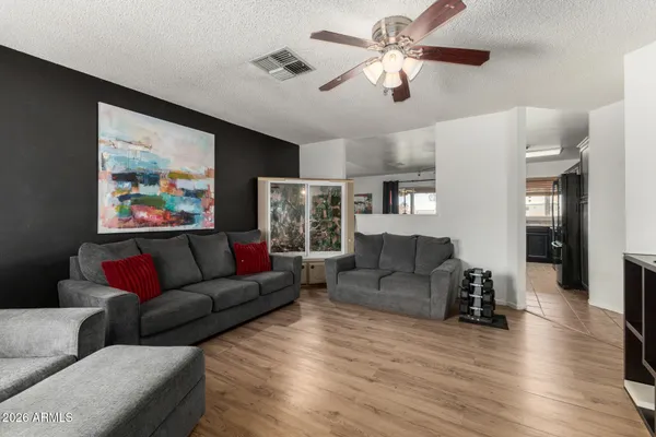 a living room with furniture and a wooden floor