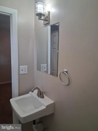 a bathroom with a sink and mirror