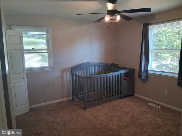 a bedroom with bed and window