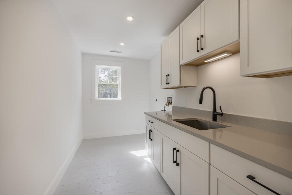 526 Marrett Road Lexington, MA 02421 - Photo 18 of 37 a kitchen with white cabinets a sink and dishwasher