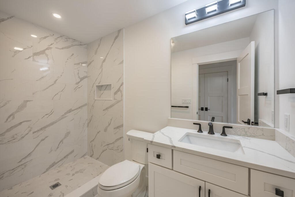 526 Marrett Road Lexington, MA 02421 - Photo 19 of 37 a bathroom with a sink a toilet and shower