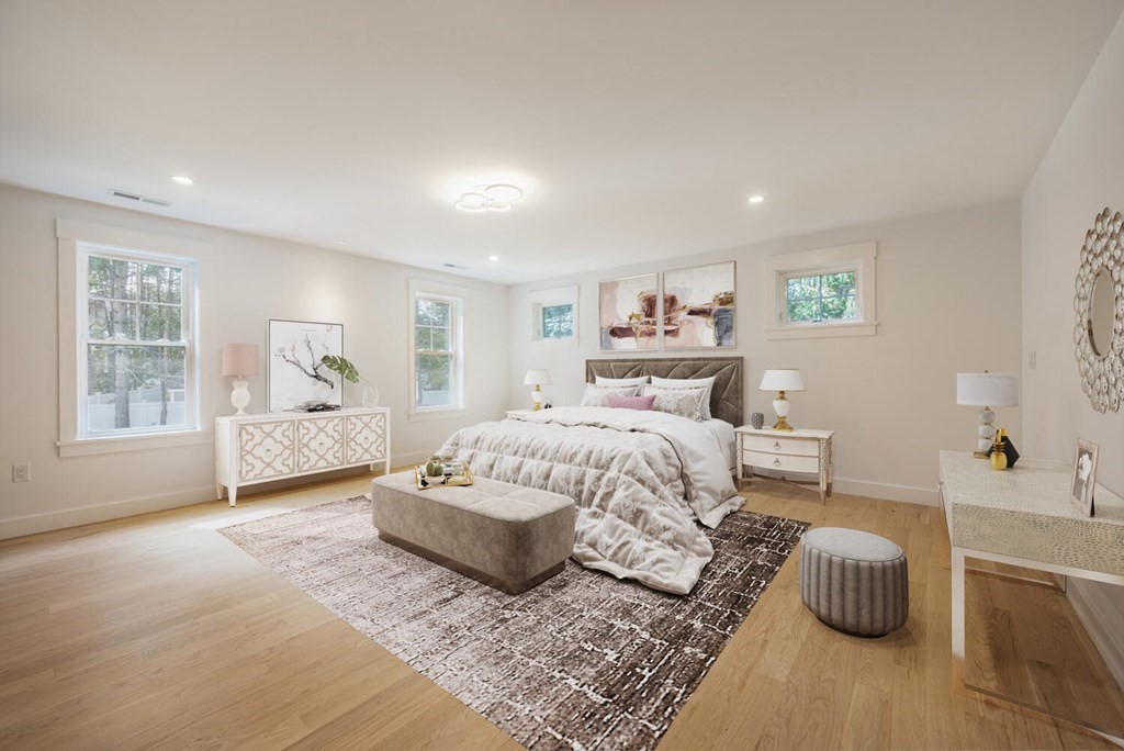 526 Marrett Road Lexington, MA 02421 - Photo 20 of 37 a spacious bedroom with a bed a couch and a window