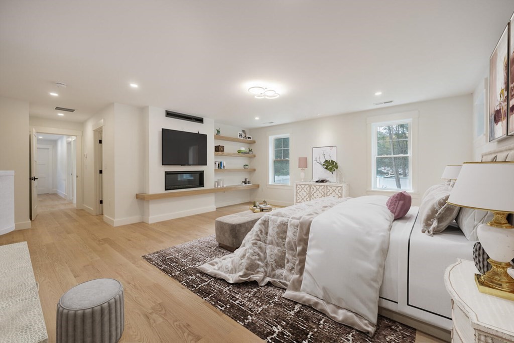 526 Marrett Road Lexington, MA 02421 - Photo 21 of 37 a large bedroom with a bed and wooden floor