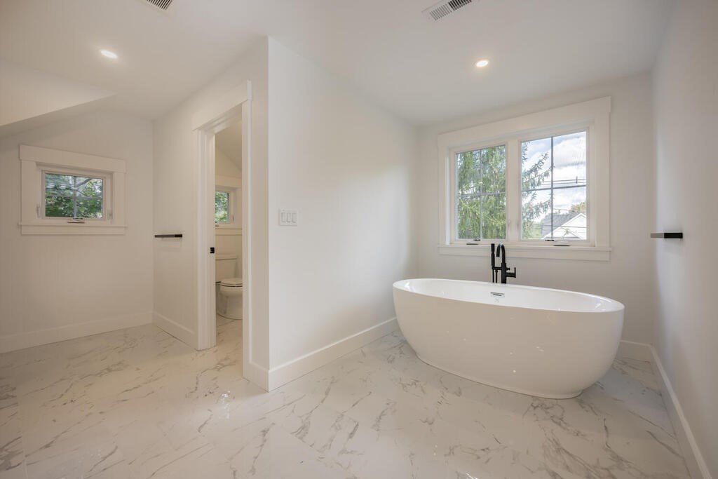 526 Marrett Road Lexington, MA 02421 - Photo 23 of 37 a spacious bathroom with a bathtub and window