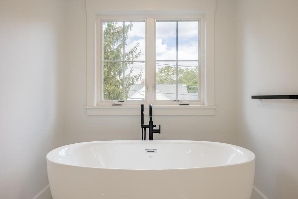 526 Marrett Road Lexington, MA 02421 - Photo 24 of 37 a white bath tub sitting in a bathroom
