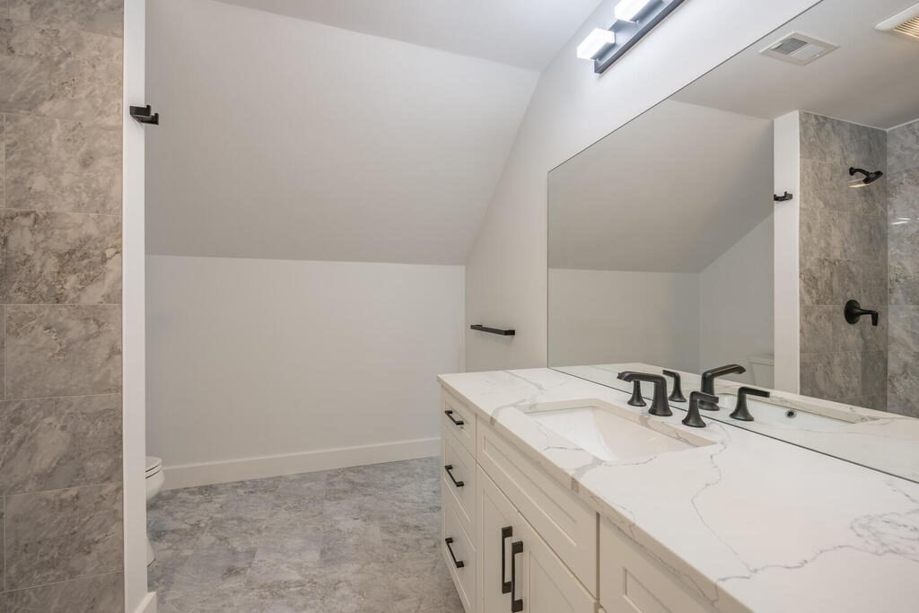526 Marrett Road Lexington, MA 02421 - Photo 30 of 37 a bathroom with a sink and a mirror