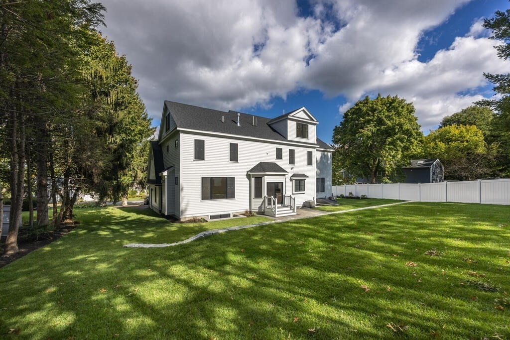 526 Marrett Road Lexington, MA 02421 - Photo 37 of 37 a white house with a big yard and large trees