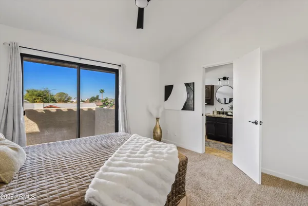 a bathroom with a granite countertop sink a toilet and a mirror