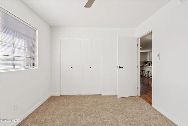 a bathroom with a granite countertop sink a mirror and a toilet